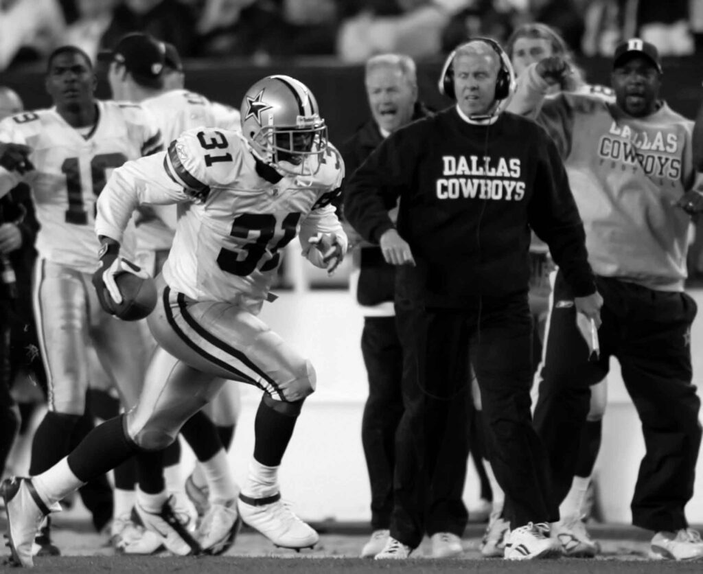 Dallas Cowboys safety Roy Williams (31) passes coach Bill Parcells as he returns a Philadelphia Eagles quarterback Donovan McNabb nterception 46 yards for a touchdown Monday, Nov. 14, 2005, in Philadelphia. The Cowboys won, 21-20. (AP Photo/Rusty Kennedy)